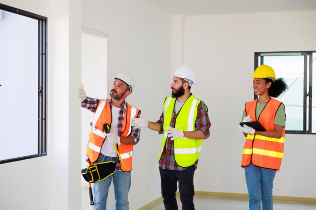 In doors Professional Mechanical Engineer team wearing safety hard hat helmet working in manufacturing factory under construction site