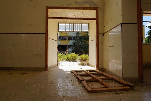 A doorway in a building with a broken door