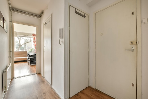 Doorway of modern apartment with white walls and parquet floor