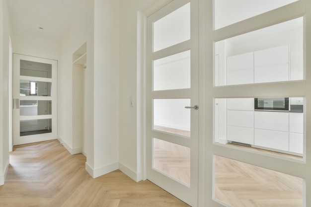 Doorway of modern apartment with white walls and parquet floor