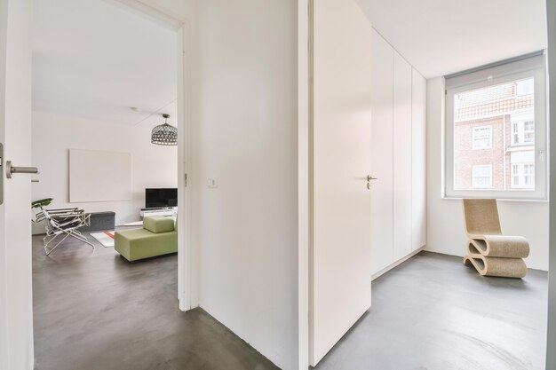 Doorway of modern apartment with white walls and parquet floor