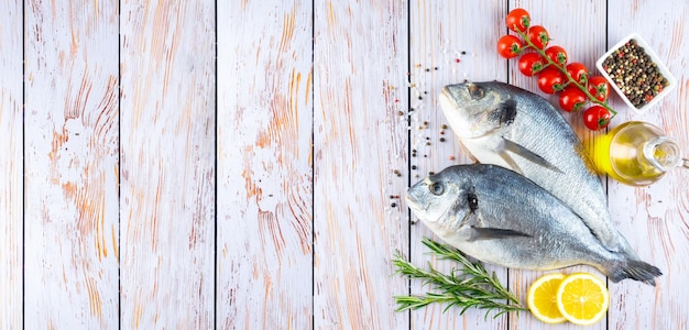 Dorado fish on white wooden background with copy space Natural food ingredients