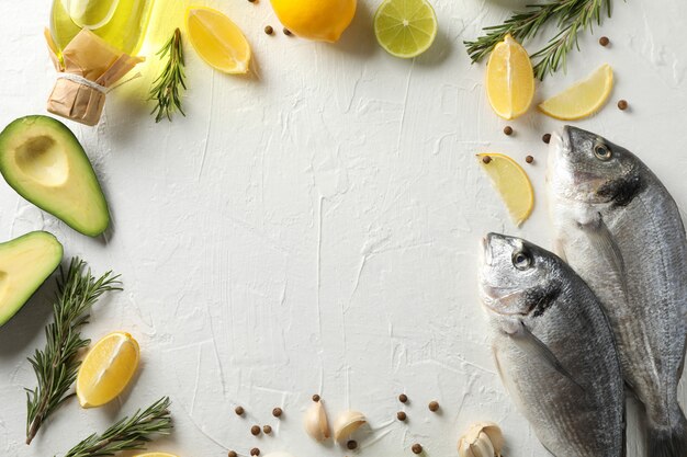 Dorado fishes and cooking ingredients on white background, space for text