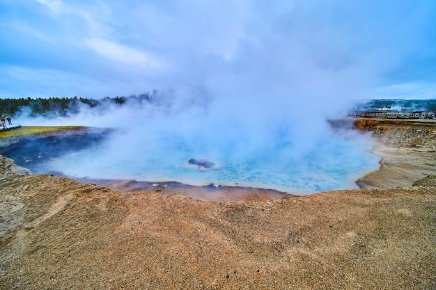 Dormant geyser and crater at Yellowstone covered in sulfur steam