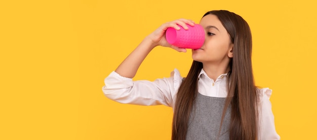 Dorstig meisje kind drinkt drank uit plastic beker met reclamebord voor kopieerruimte dorst Horizontaal posterontwerp Webbanner koptekst kopieerruimte