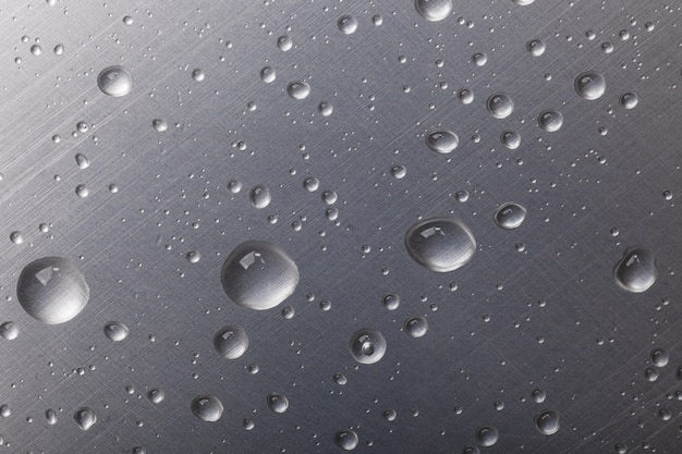 Dots of water on dark metal background