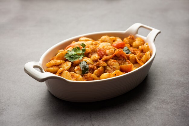 Double beans curry sabzi or sabji recipe made using basic Indian spices and fresh tomatoes, served in a bowl. selective focus