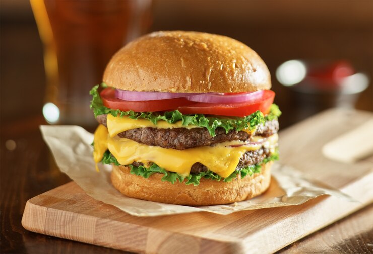Photo double cheeseburger with lettuce, tomato, onion, and melted american cheese