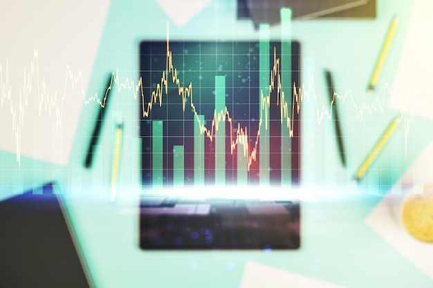 Double exposure of abstract creative financial chart and digital tablet on background top view research and strategy concept