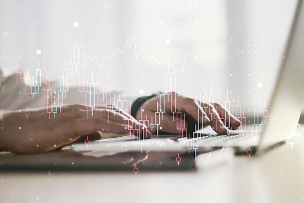 Double exposure of abstract creative financial chart with hand typing on computer keyboard on background research and strategy concept