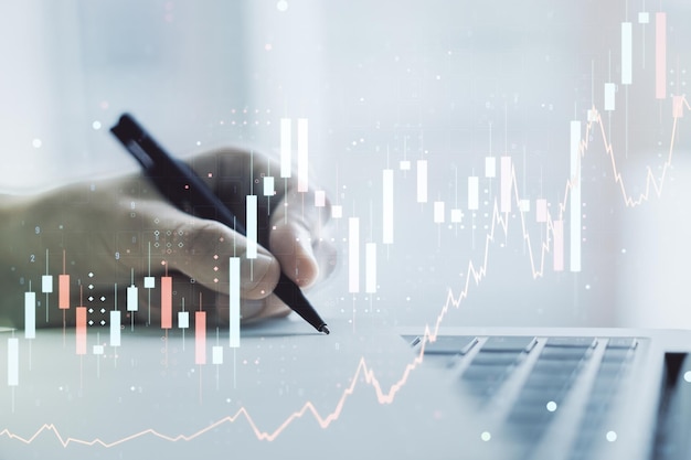 Double exposure of abstract creative financial chart with hand writing in notebook on background research and strategy concept