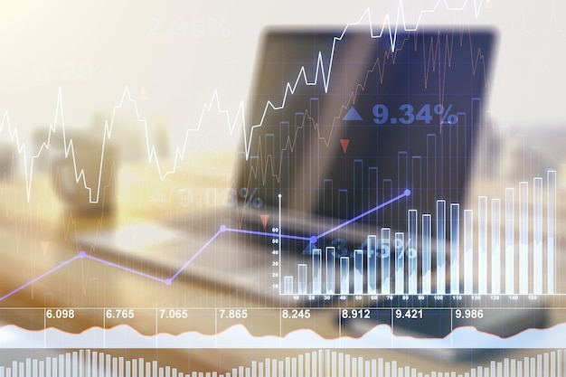 Double exposure of abstract creative financial diagram and modern desk with computer on background banking and accounting concept