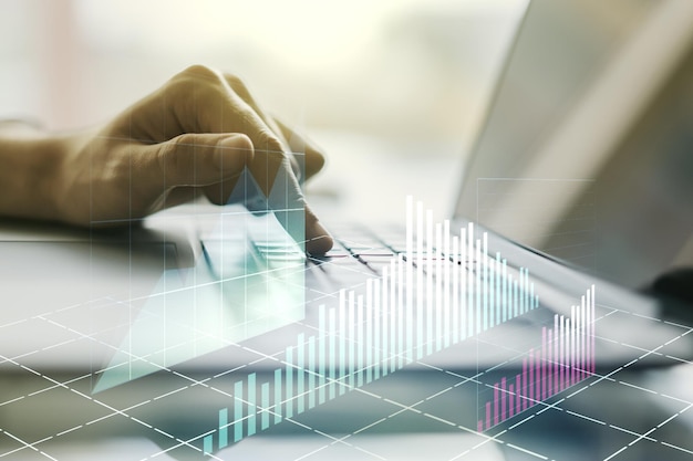 Double exposure of abstract creative financial diagram with hand typing on computer keyboard on background banking and accounting concept