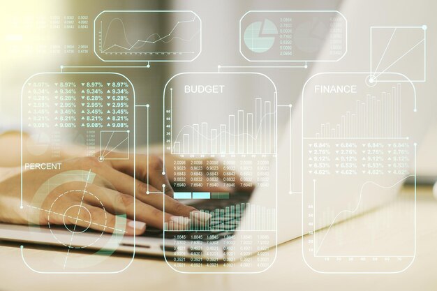 Double exposure of abstract creative statistics data hologram\
with hands typing on laptop on background analytics and forecasting\
concept