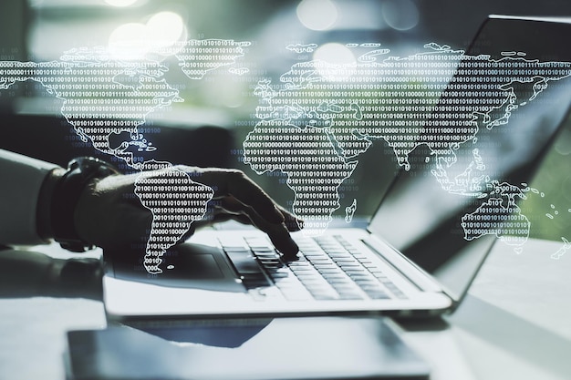 Double exposure of abstract digital world map and hand typing on laptop on background big data and blockchain concept