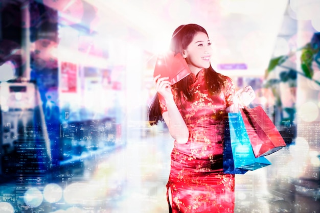 Double exposure of beautiful woman carrying angpao