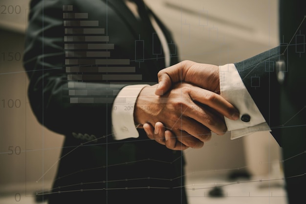 Photo double exposure of business people shaking hands finishing up a meetingnegotiations were successfully