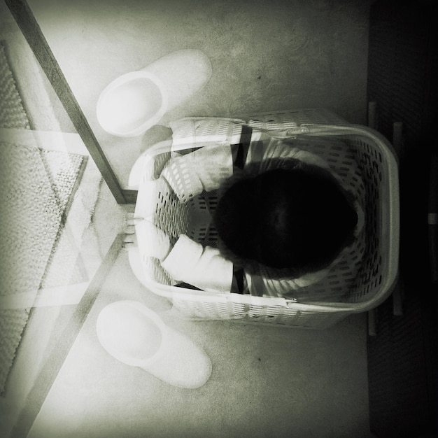 Photo double exposure of child sitting in basket and shoes