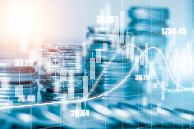 Double exposure of coins stacking with investment graph chart and cityscape. It is symbol of stock value investment concept.