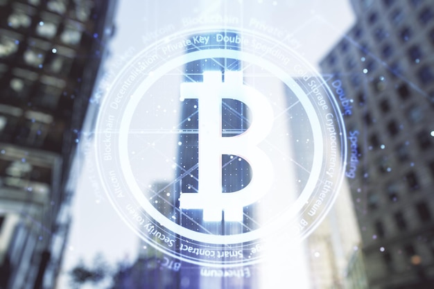 Double exposure of creative Bitcoin symbol hologram on blurry cityscape background Mining and blockchain concept