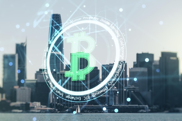 Double exposure of creative Bitcoin symbol hologram on San Francisco office buildings background Mining and blockchain concept