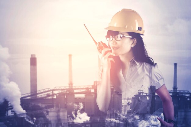 Double exposure of engineer talking on walkie talkie