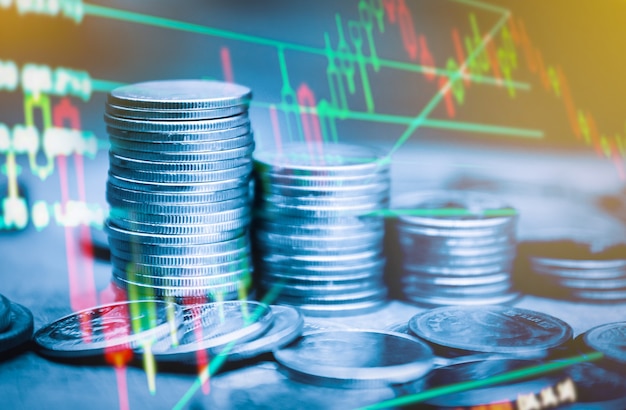 double exposure of finance graph  stationary and rows of coins for goal office