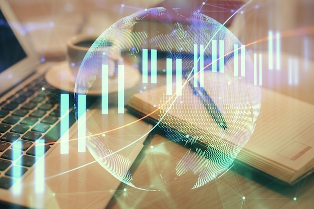 Double exposure of financial chart drawing and desktop with coffee and items on table background Concept of forex market trading