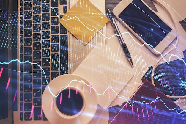 double exposure of financial chart drawing over table background with computer concept of research and analysis top view