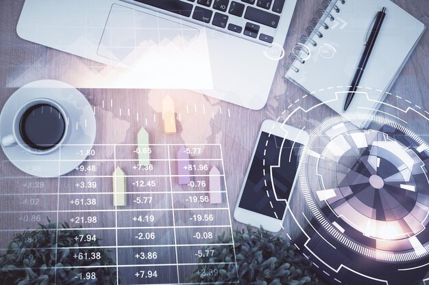 Double exposure of financial chart hologram over desktop with phone Top view Mobile trade platform concept