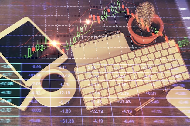 Double exposure of forex chart hologram over desktop with phone Top view Mobile trade platform concept