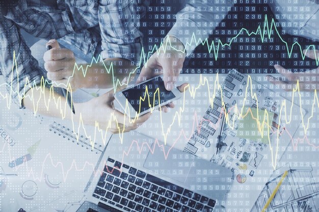 Double exposure of forex graph drawing and man and woman working together holding and using a mobile device Trade concept