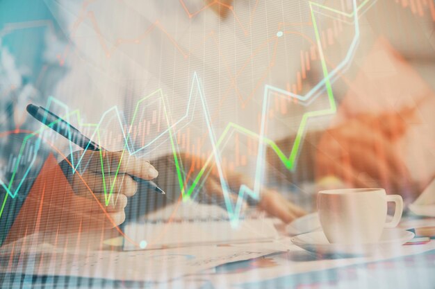 Double exposure of forex graph drawing over people taking notes background Concept of financial analysis