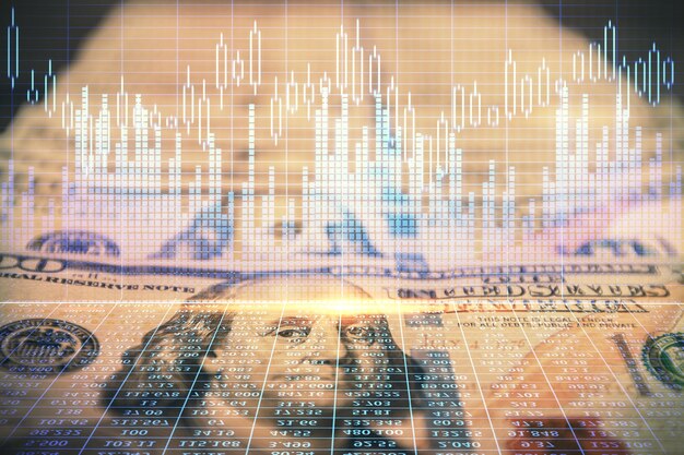 Foto doppia esposizione del grafico forex che disegna sullo sfondo della banconota in dollari statunitensi il concetto di mercati finanziari