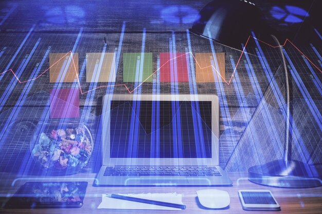 Double exposure of forex graph and work space with computer Concept of international online trading