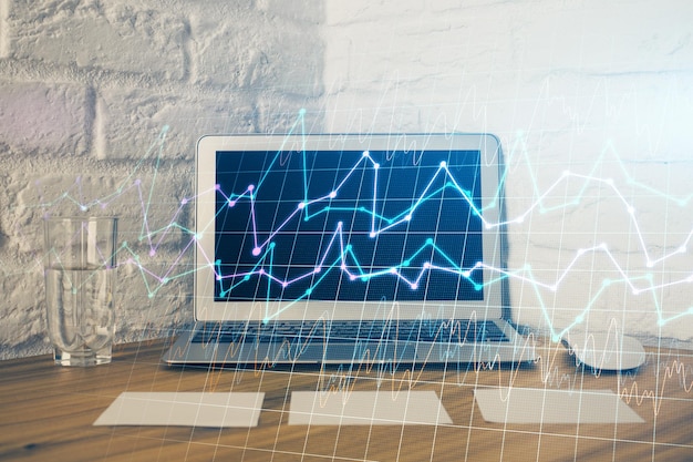 Double exposure of forex graph and work space with computer Concept of international online trading