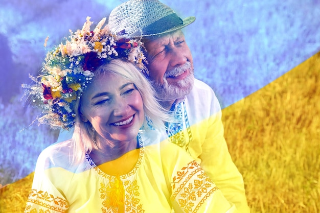 Double exposure of happy mature couple wearing national clothes in field and Ukrainian flag