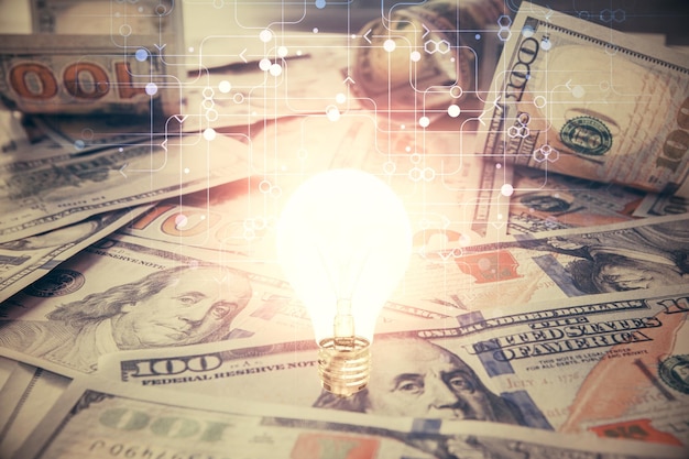 Double exposure of light bulb drawing over usa dollars bill background Concept of idea