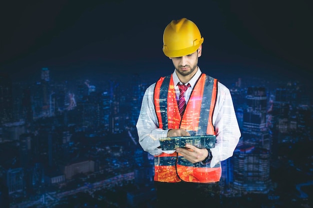 Double exposure of male engineer with skyscraper