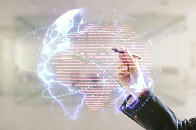 Double exposure of man hand with pen working with abstract digital world map hologram with connections on blurred office background big data and blockchain concept