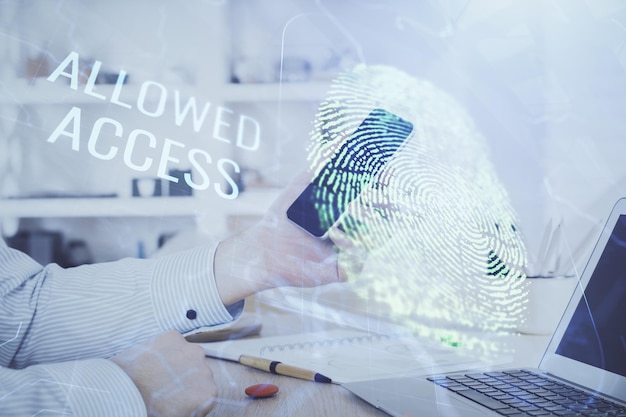 Double exposure of man's hands holding and using a digital device and fingerprint hologram drawing Security concept