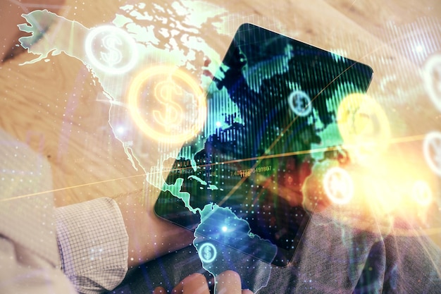 Double exposure of man's hands holding and using a digital device and forex graph drawing Financial market concept