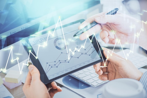 Double exposure of man's hands holding and using a phone and financial chart drawing Market analysis concept