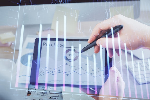 Double exposure of man's hands holding and using a phone and financial chart drawing Market analysis concept