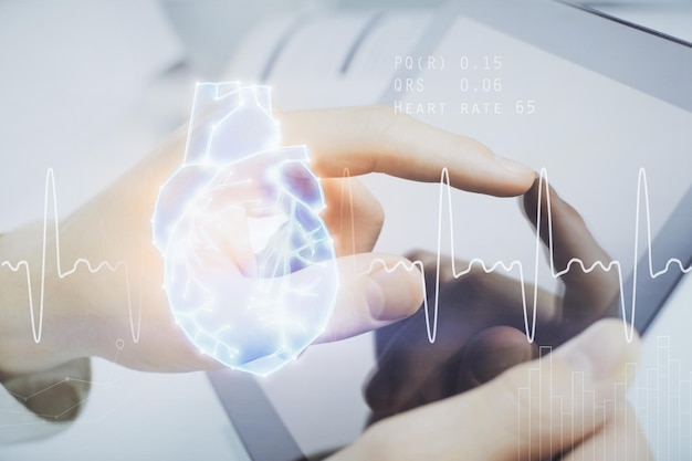 Double exposure of man's hands holding and using a phone and heart drawing Medical education concept