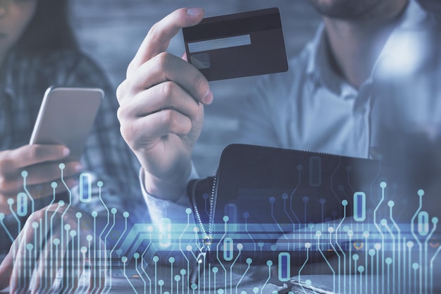 Double exposure of man and woman online shopping holding a credit card and data theme hologram drawing Ai and Ecommerce pay online concept