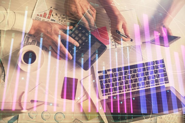 Double exposure of man and woman working together and financial chart hologram drawing market analysis concept Computer background Top View