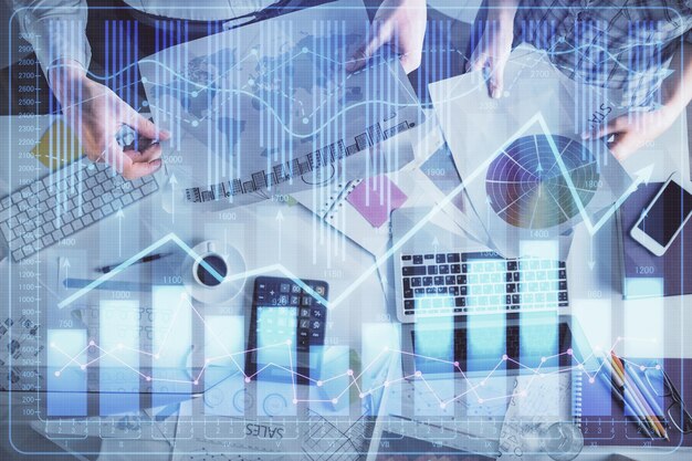 Double exposure of man and woman working together and financial chart hologram drawing market analysis concept Computer background Top View