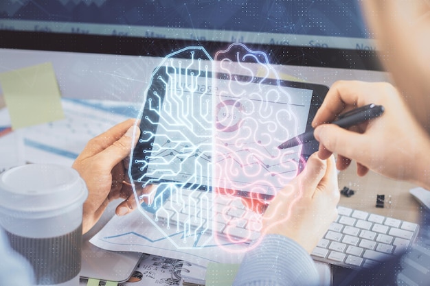 Double exposure of mans hand holding and using a digital device and brain hologram drawing Data concept