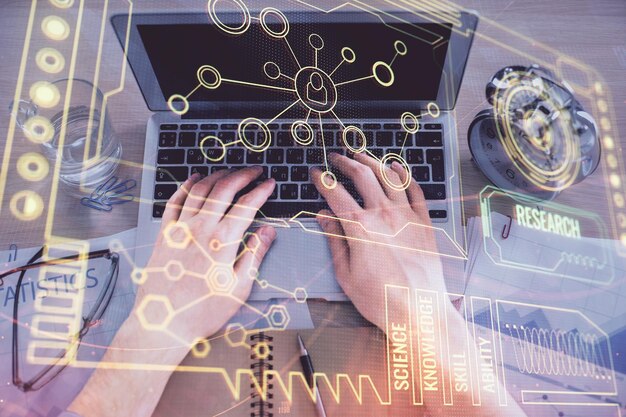 double exposure of mans hands typing over computer keyboard and data theme hologram drawing top view technology concept